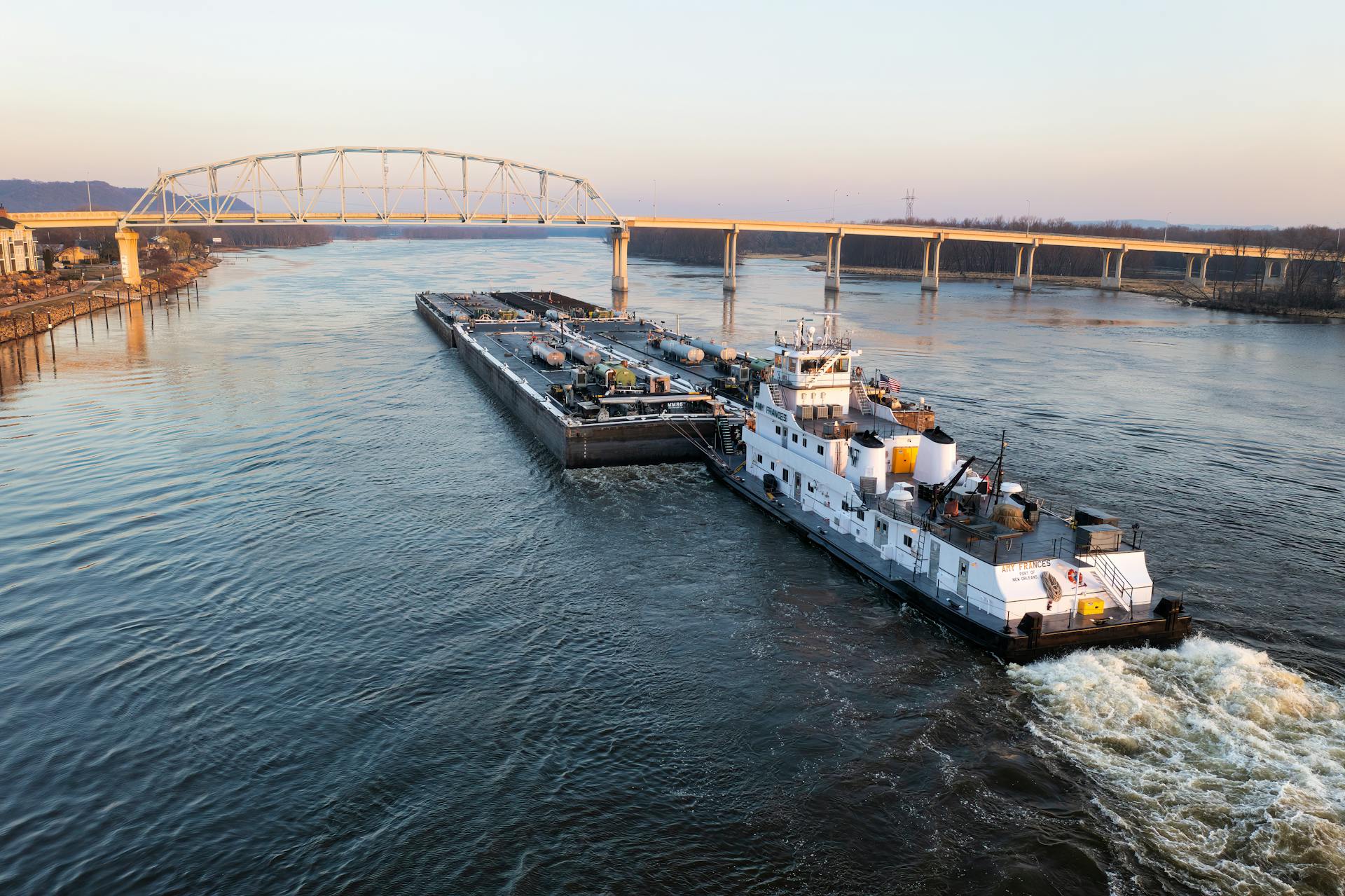 Barge traveling on the Mississippi River near Wabasha, Minnesota during an early spring morning.