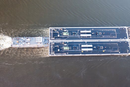 Aerial shot of a commercial river barge navigating the waterway in Wabasha, Minnesota.