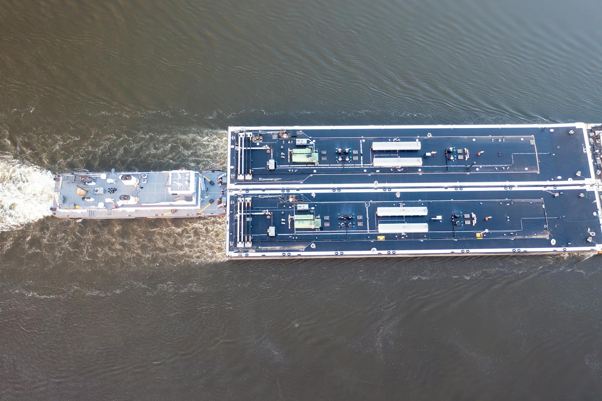 Aerial shot of a commercial river barge navigating the waterway in Wabasha, Minnesota.