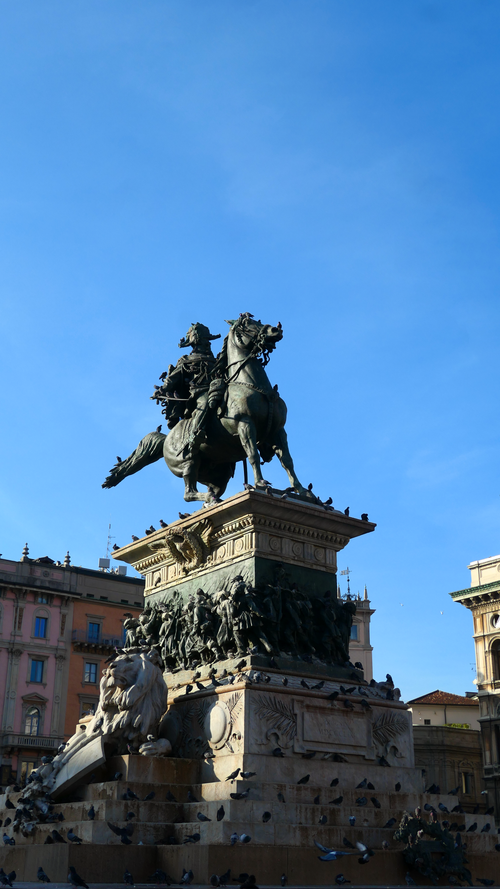 Free Iconic equestrian statue in Piazza del Duomo, Milan, under a clear blue sky. Stock Photo