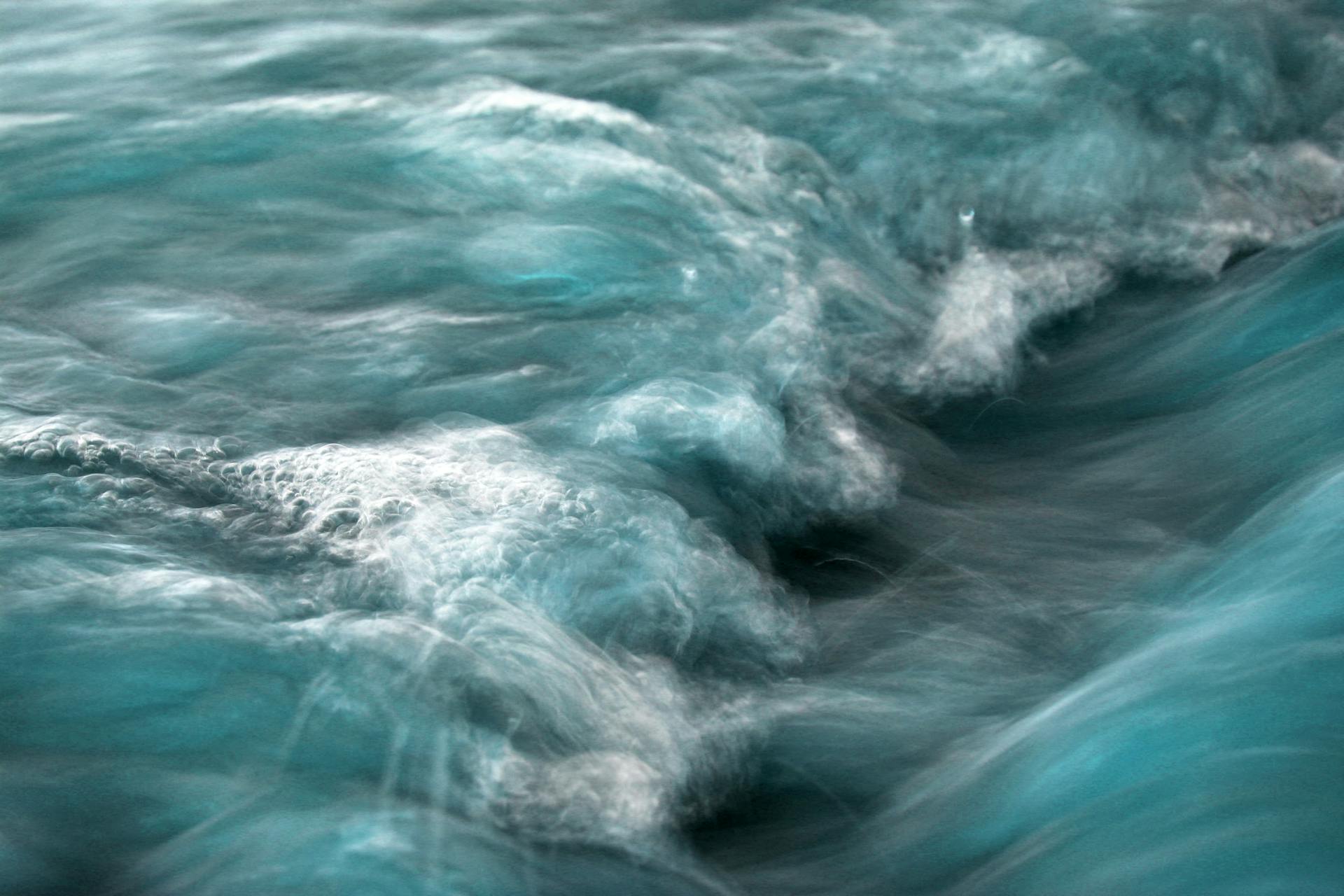 Captivating ocean waves in motion at Guaratuba, Paraná, Brasil, showcasing vibrant blues and white froth.