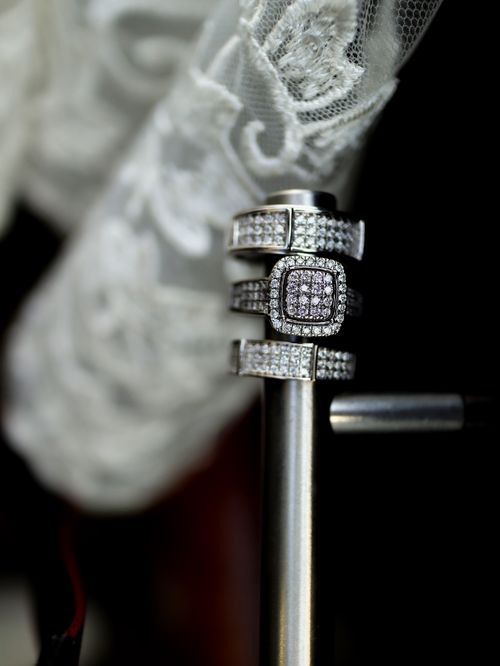 Free Close-up of elegant silver rings adorned with diamonds, showcasing intricate design against a lace backdrop. Stock Photo