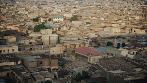Free A sprawling aerial cityscape showcasing densely packed urban architecture in a neutral tone. Stock Photo