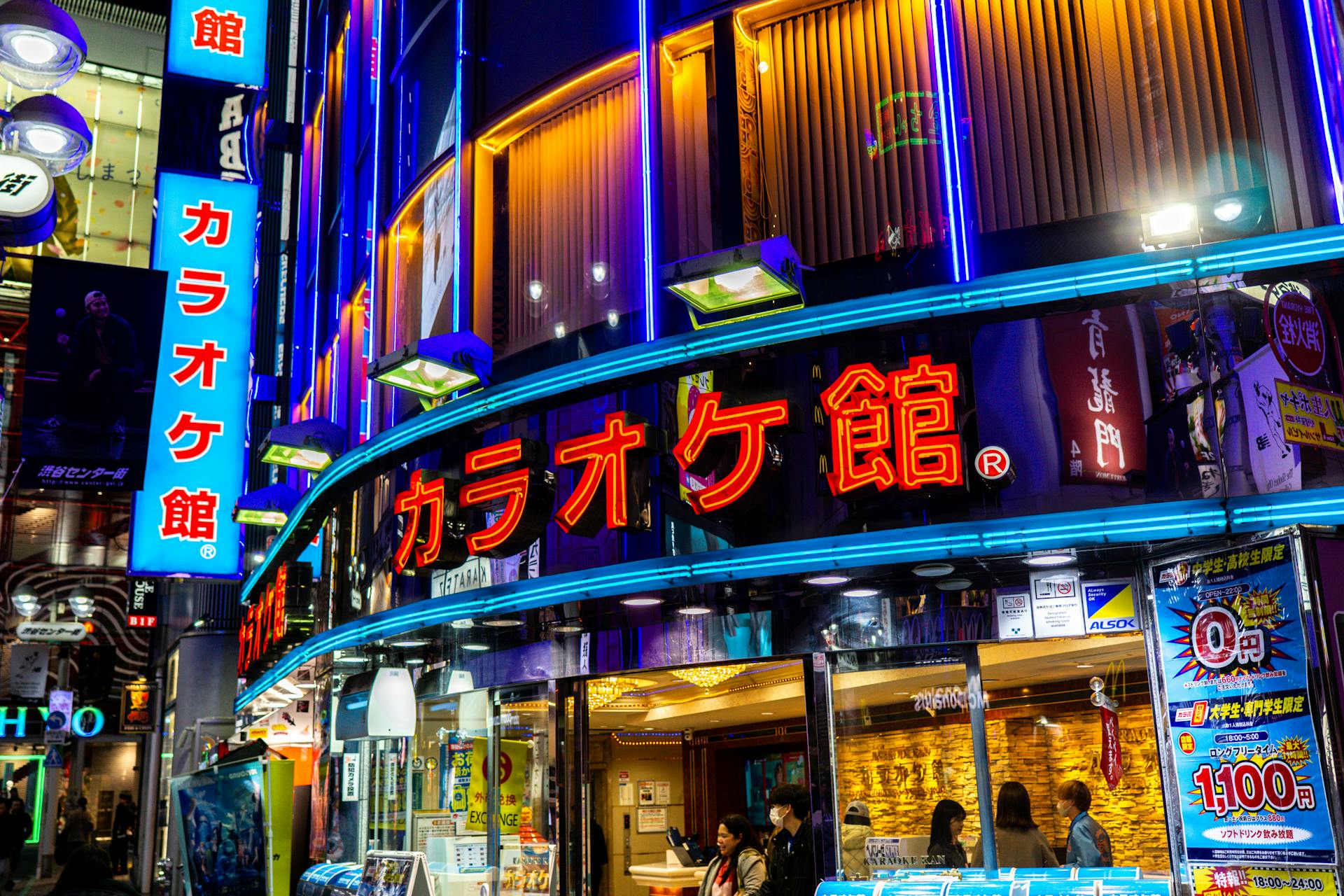 Explore lively Tokyo nightlife with vibrant neon signs on a bustling street. Perfect for urban culture themes.