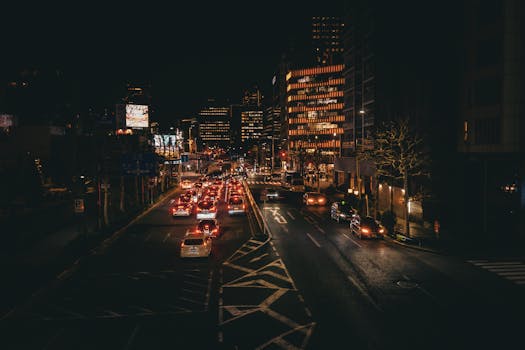 Vibrant nighttime cityscape showcasing busy Tokyo streets illuminated with city lights.