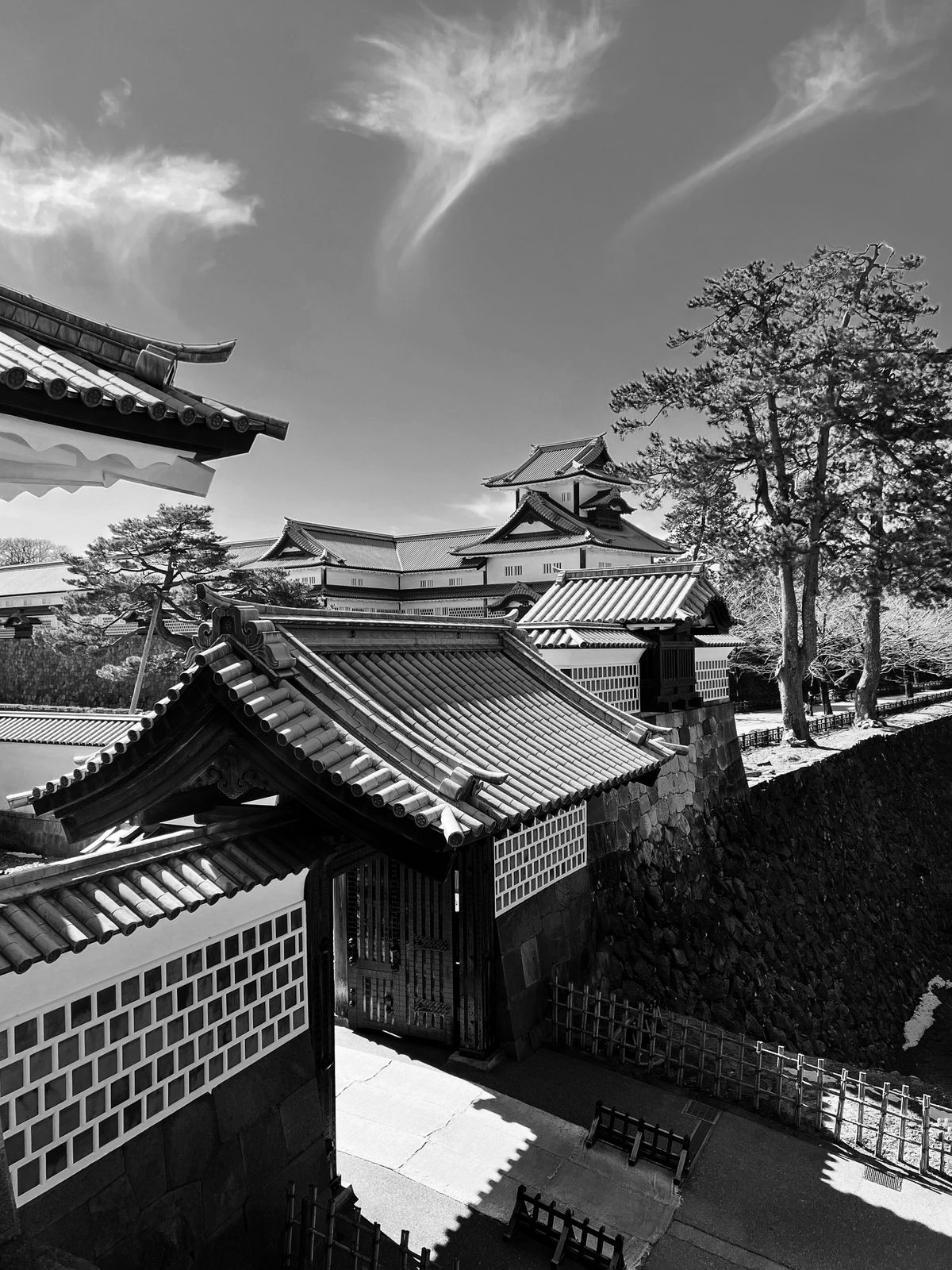 The traditional white-walled towers and stone walls of Kanazawa Castle