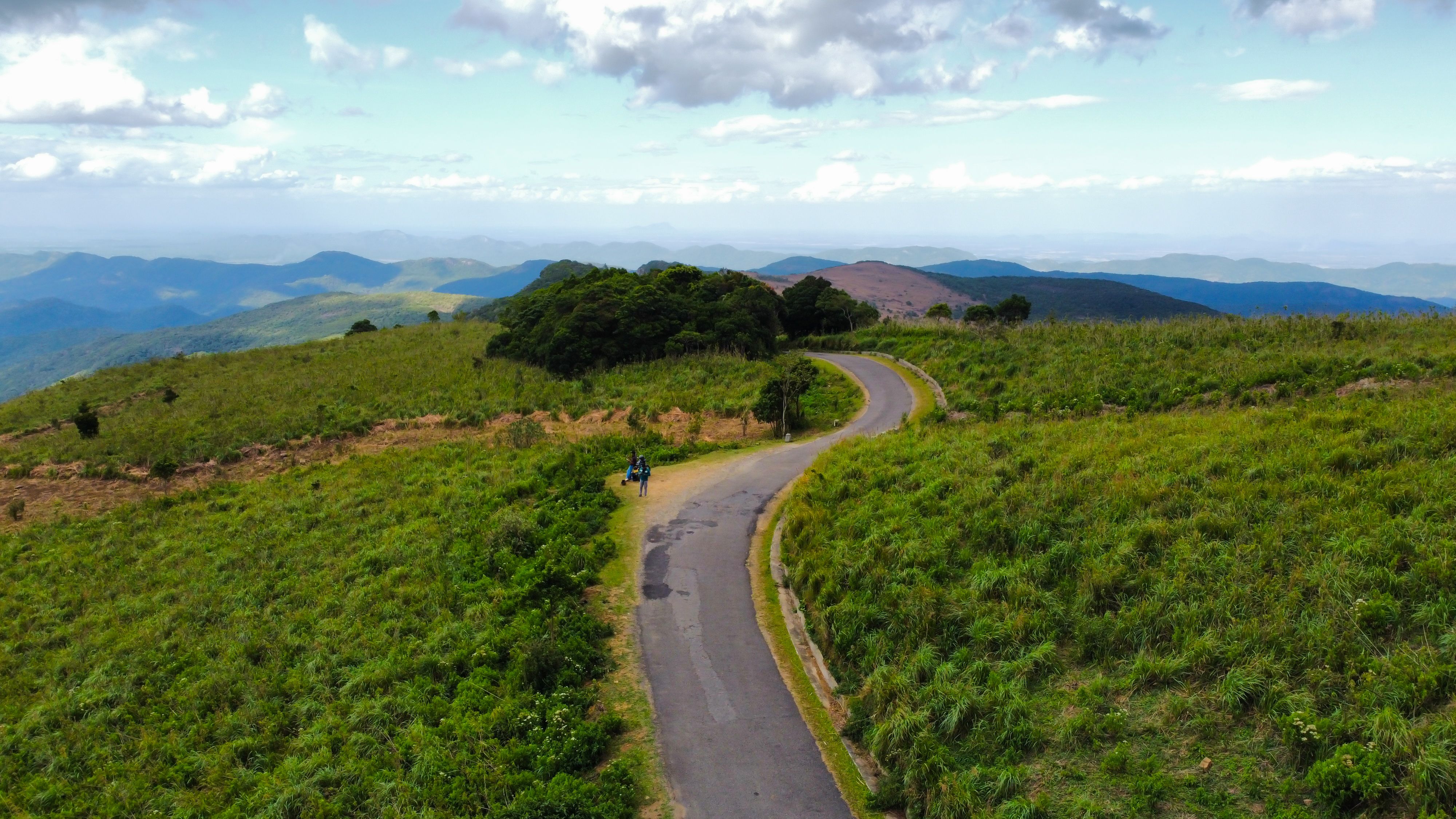 Aerial view of a winding road through verdant Sri Lankan hills