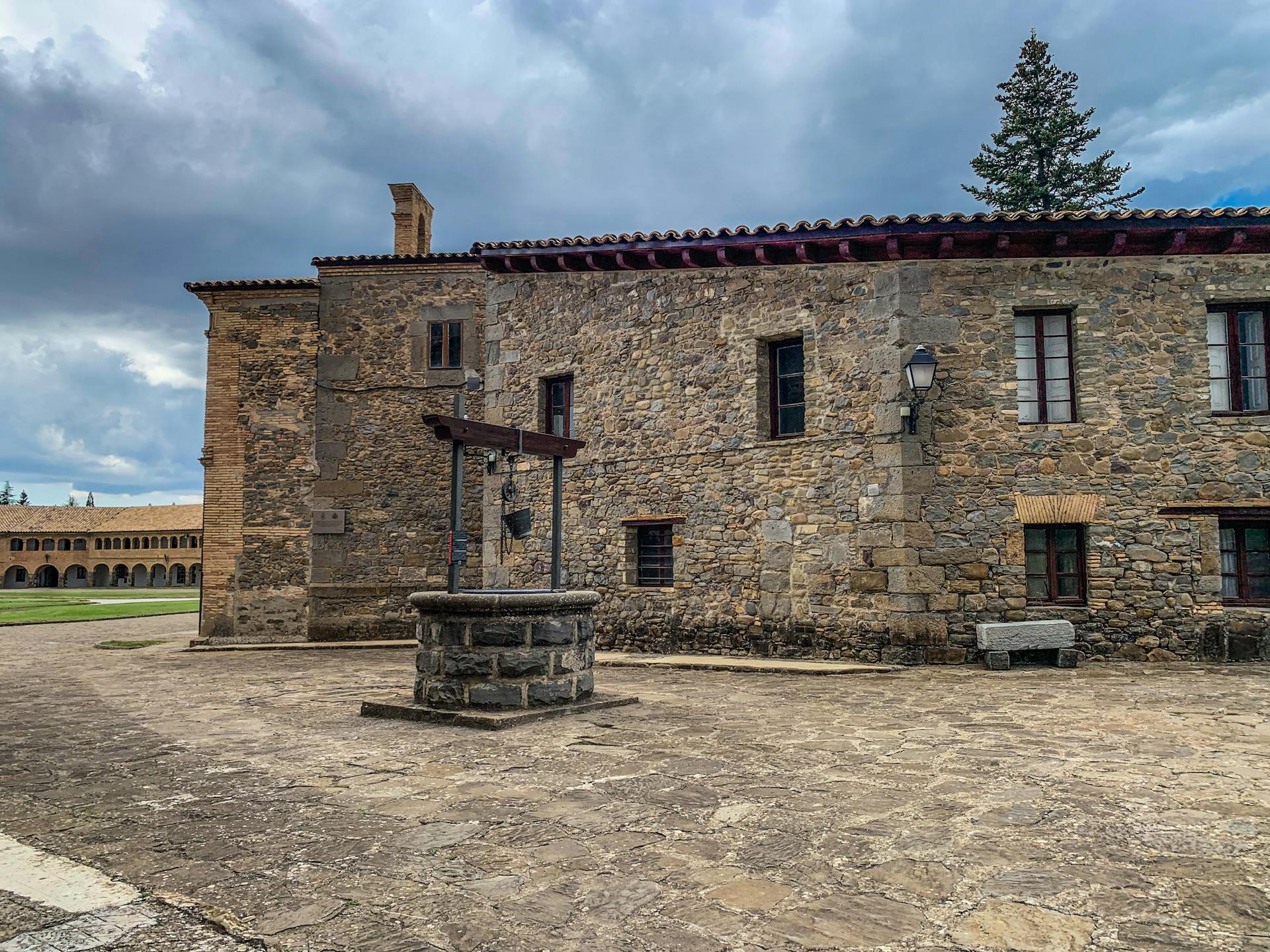 Old stone building and well under cloudy skies. Historic architecture captured outdoors.