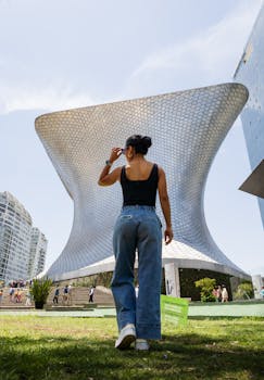 Woman standing outside Museo Soumaya, Mexico City, a modern architectural landmark.