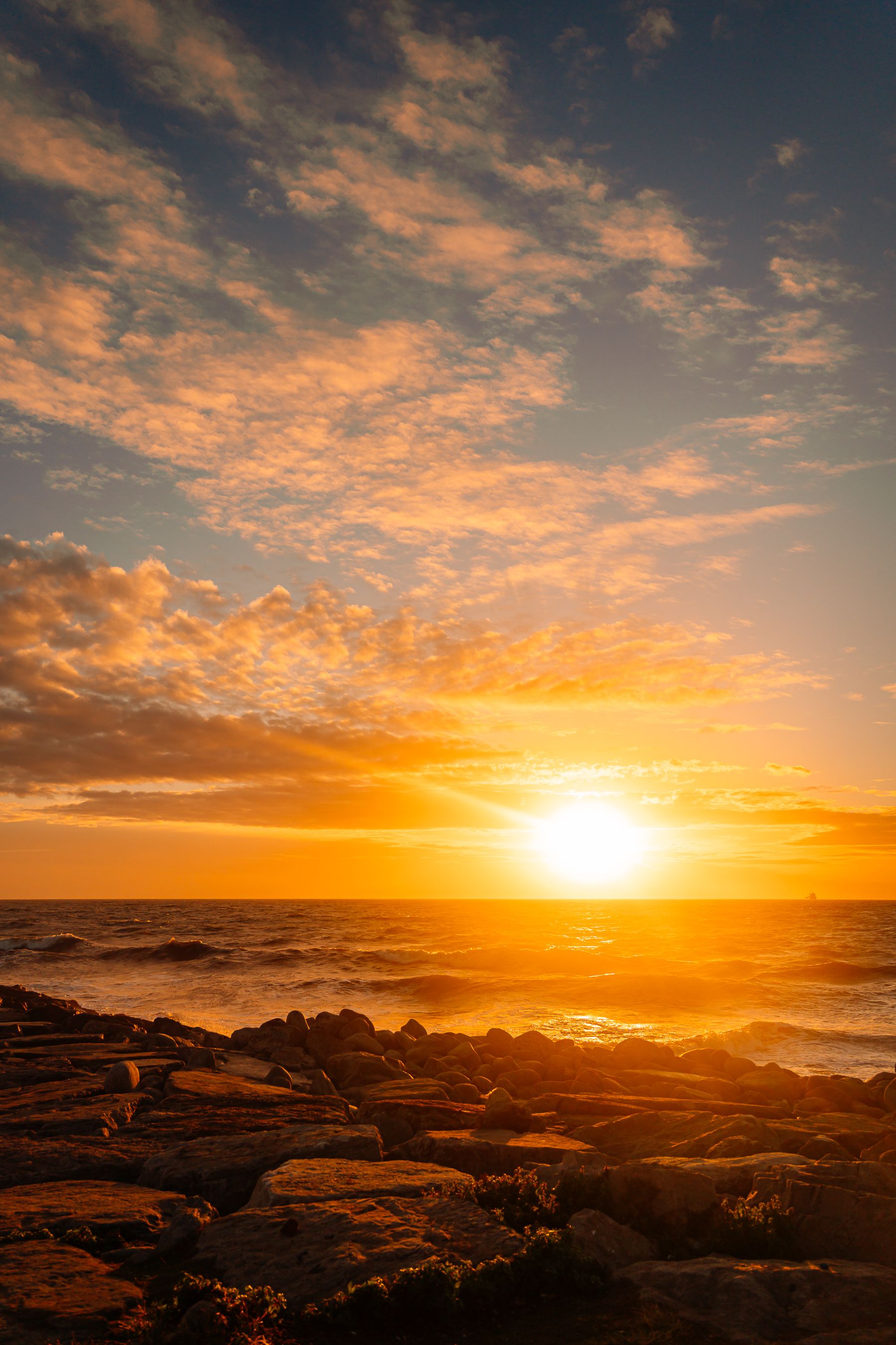 Gorgeous Ocean Sunset Over Rocky Shoreline · Free Stock Photo