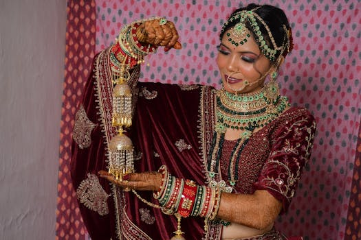 A stunning South Asian bride adorned in traditional jewelry and attire, showcasing intricate henna designs.