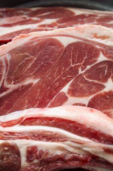 Detailed close-up of raw lamb chops showing marbling and texture.