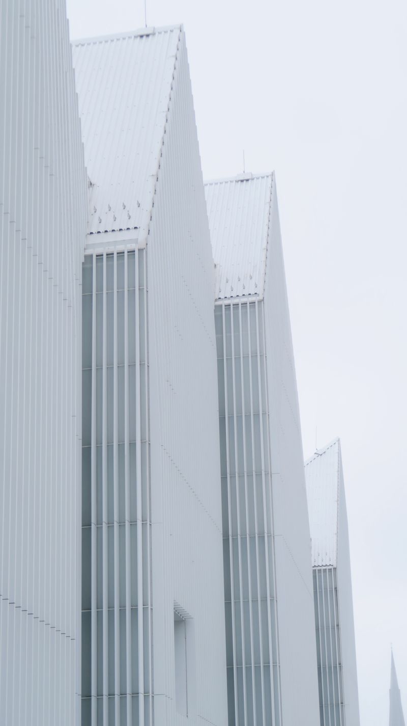 White angular roof forms against a pale sky — photo by Jiajia on Pexels