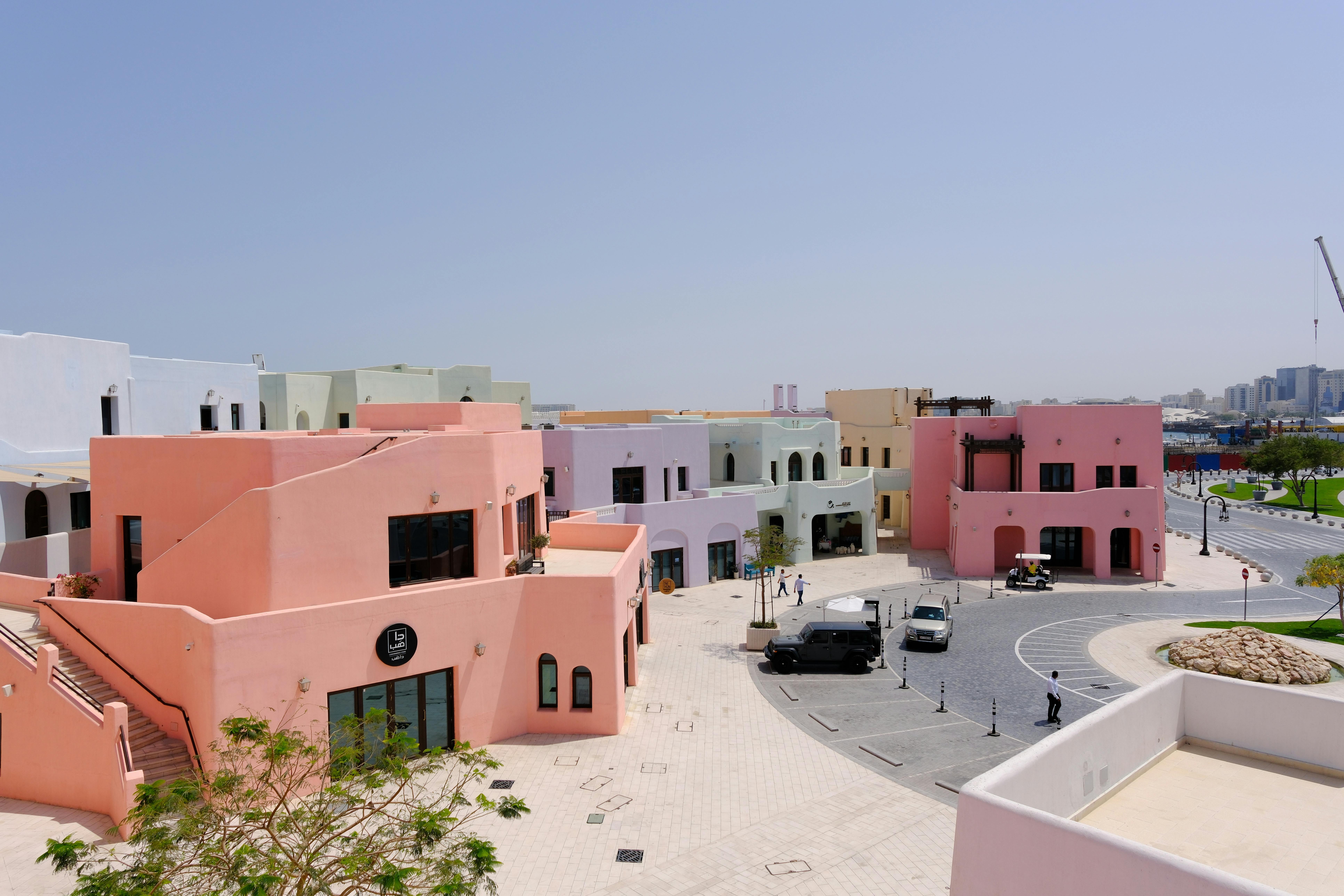 A vibrant scene depicting pastel-colored buildings in a contemporary urban area.