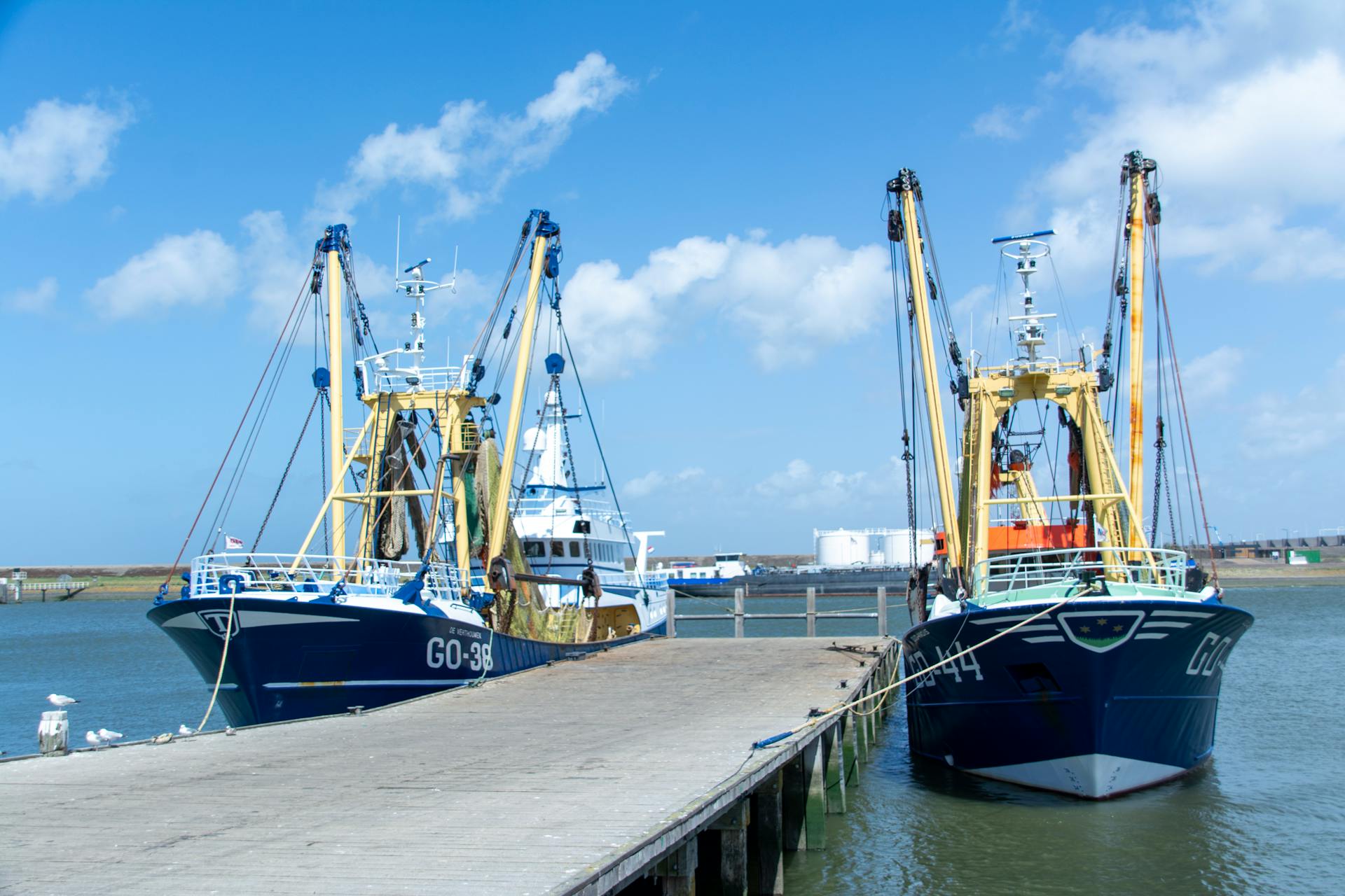 Commercial fishing boats docked in Stellendam port on a sunny day.