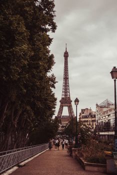 A captivating view of the iconic Eiffel Tower from a bustling street in Paris, France.