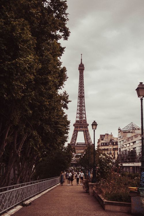 Free A captivating view of the iconic Eiffel Tower from a bustling street in Paris, France. Stock Photo