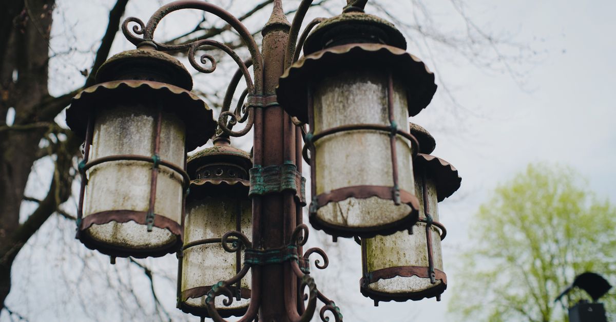 Rusty Lantern Antique Rusty Lanterns Against Spring Trees · Free Stock Photo