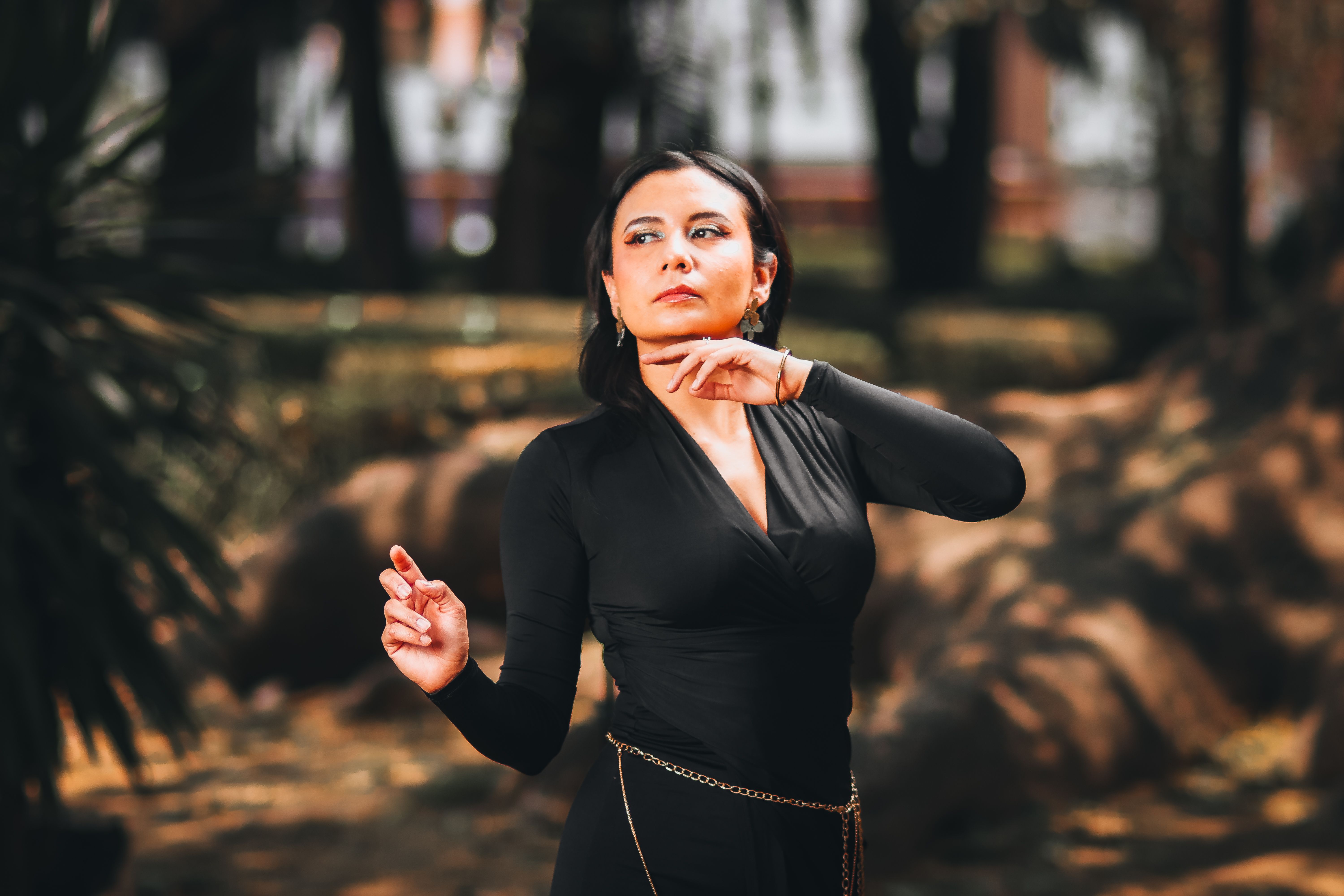 Elegant Woman Posing in Urban Park · Free Stock Photo