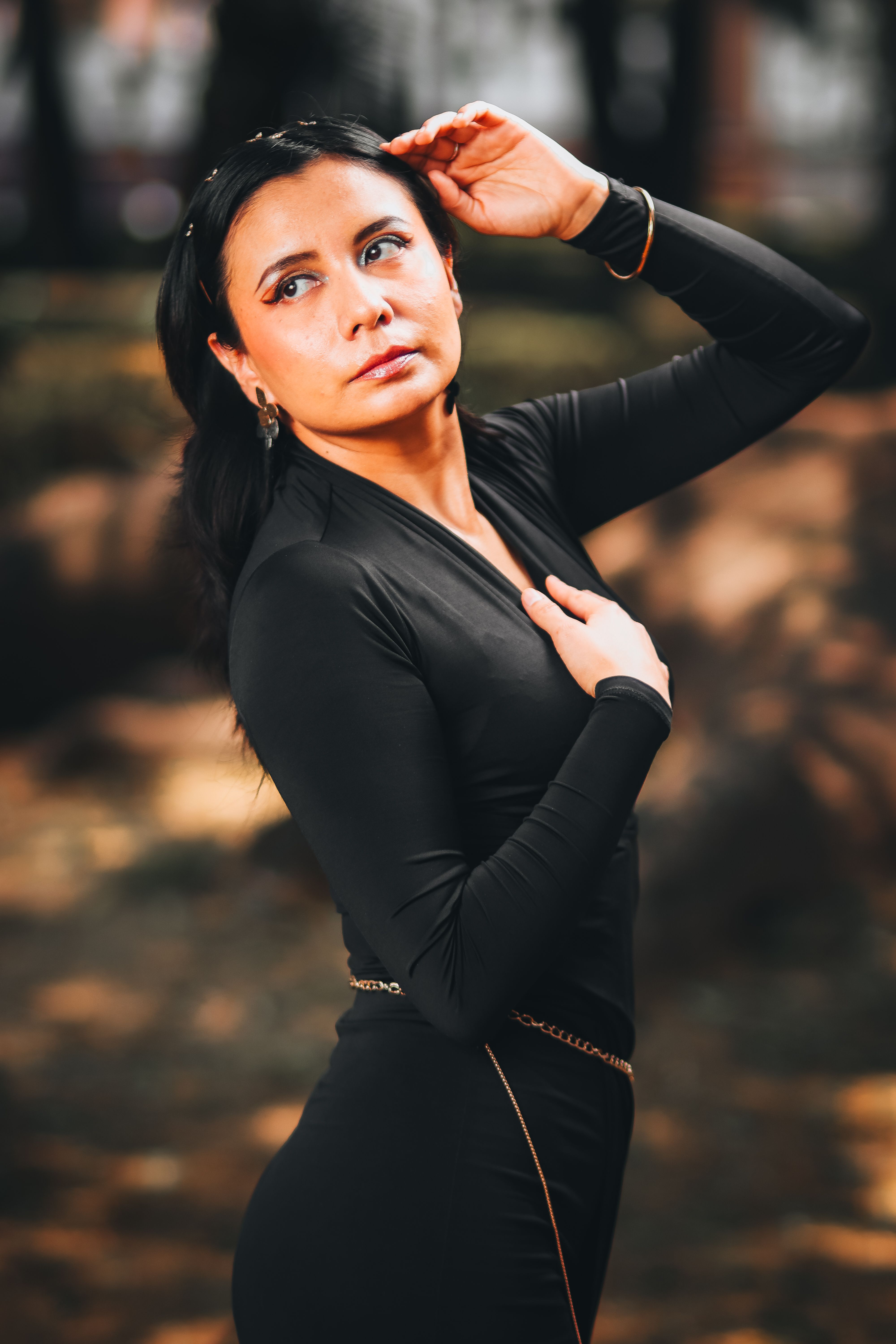 Elegant Woman Posing in Urban Park · Free Stock Photo