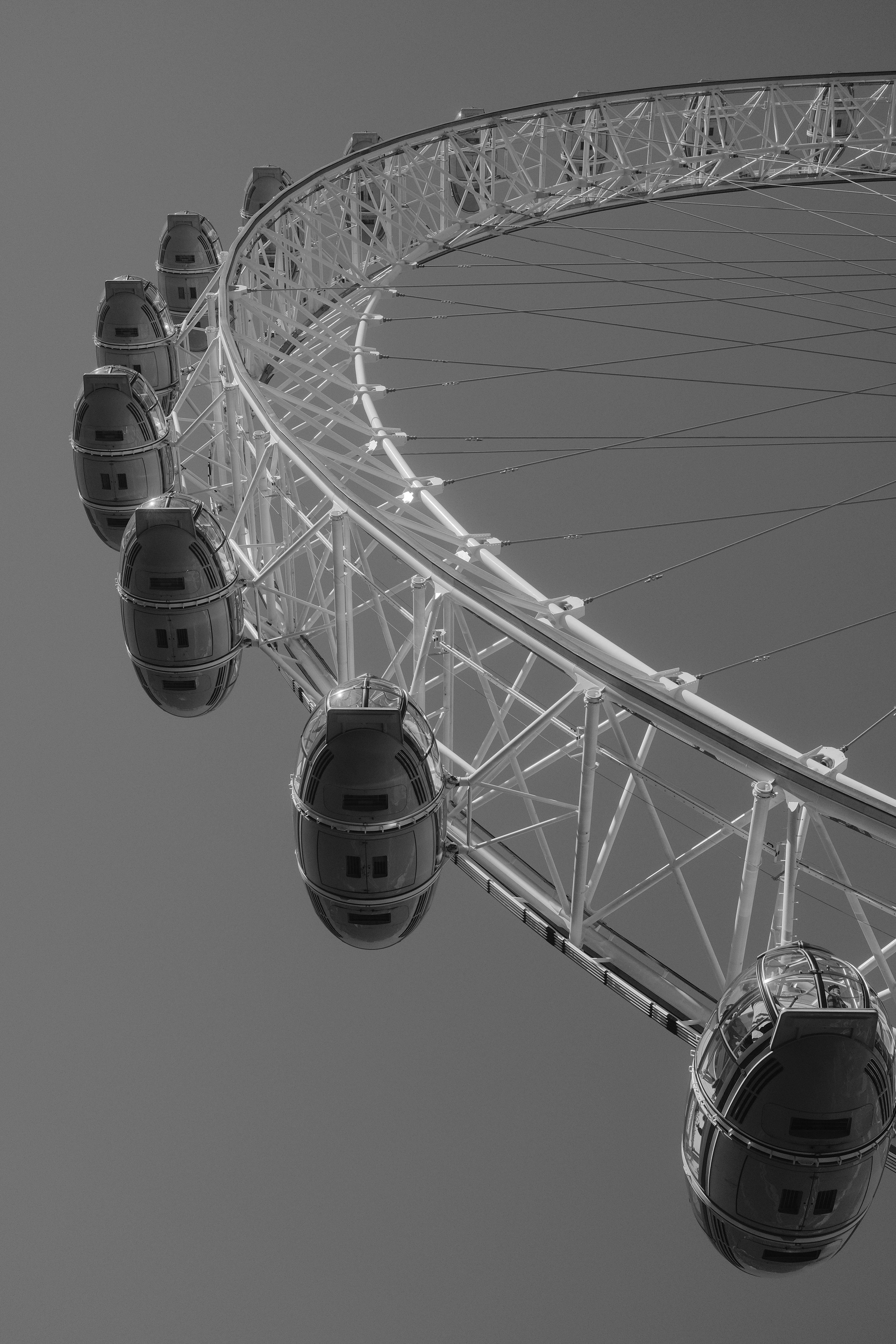 A dramatic black and white photo of the London Eye ferris wheel in London, UK.