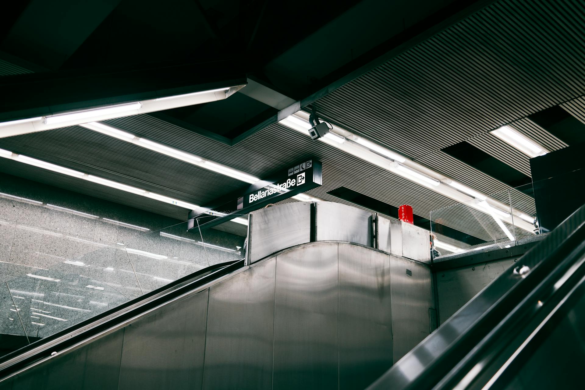 Sleek modern subway station interior in Berlin featuring escalators and minimalistic design elements.