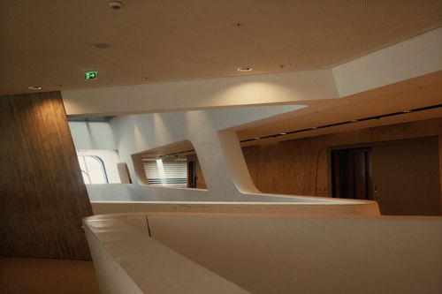Free Contemporary interior with geometric architecture and warm tones. Stock Photo