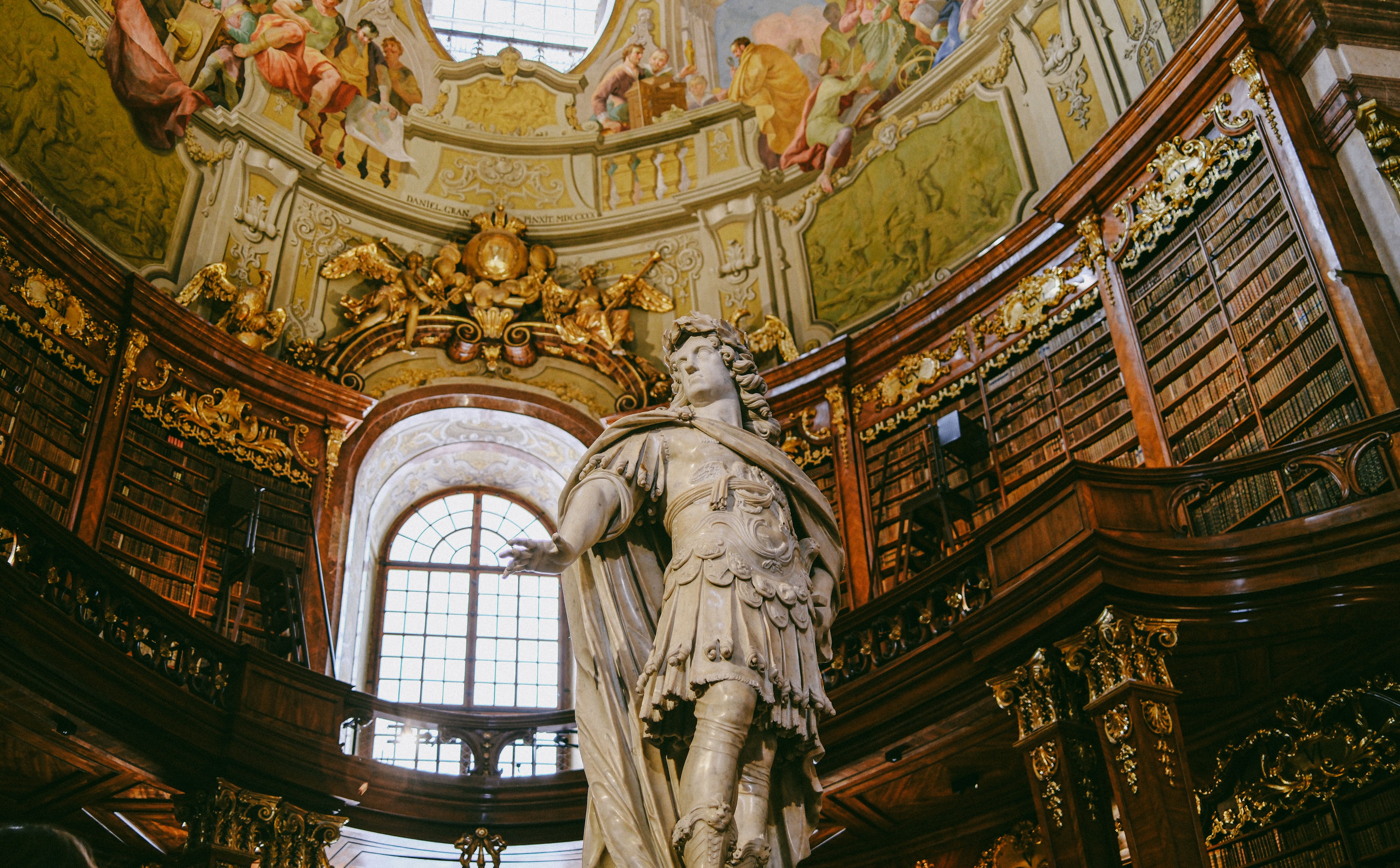 Ornate Baroque Library with Marble Statue · Free Stock Photo