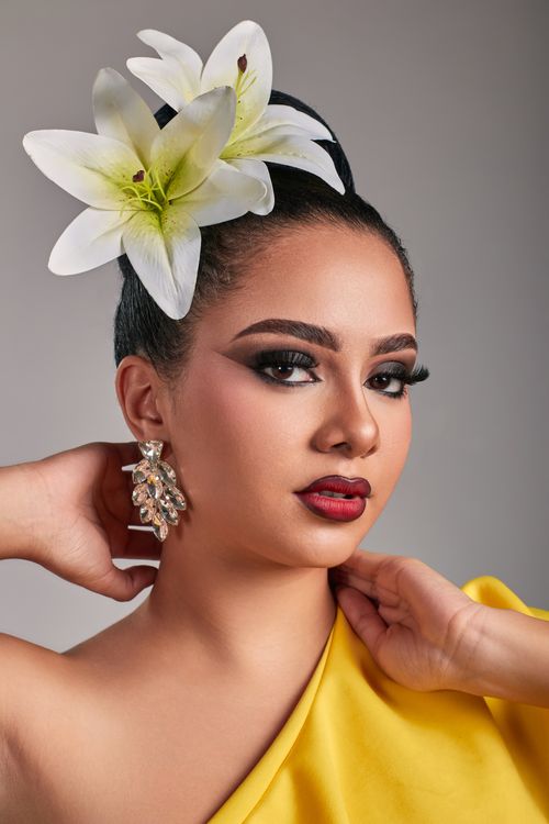 Free Stylish portrait of a woman wearing lilies, focus on beauty and elegance. Stock Photo