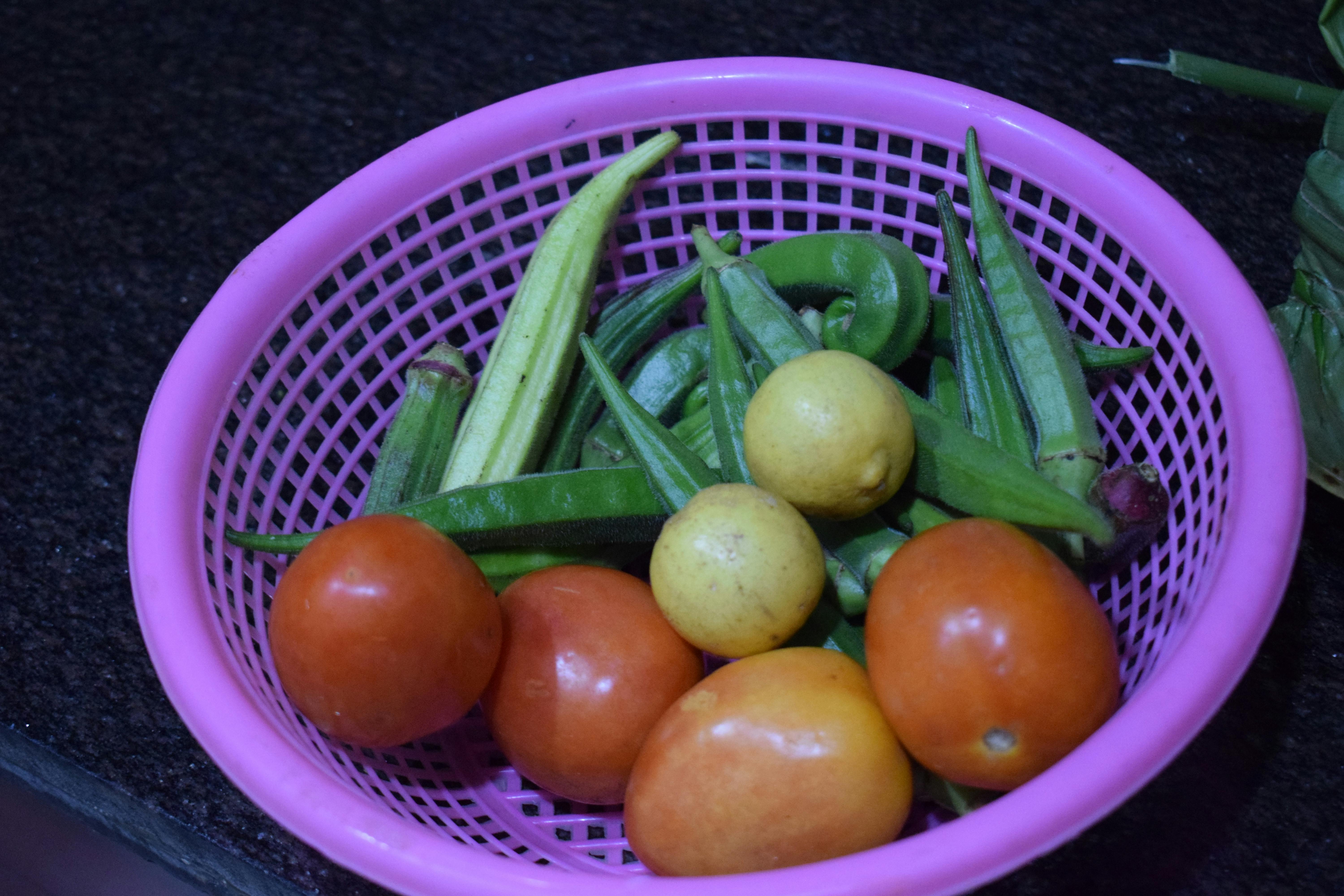 Top-down view of hands writing notes in a notebook beside a laptop