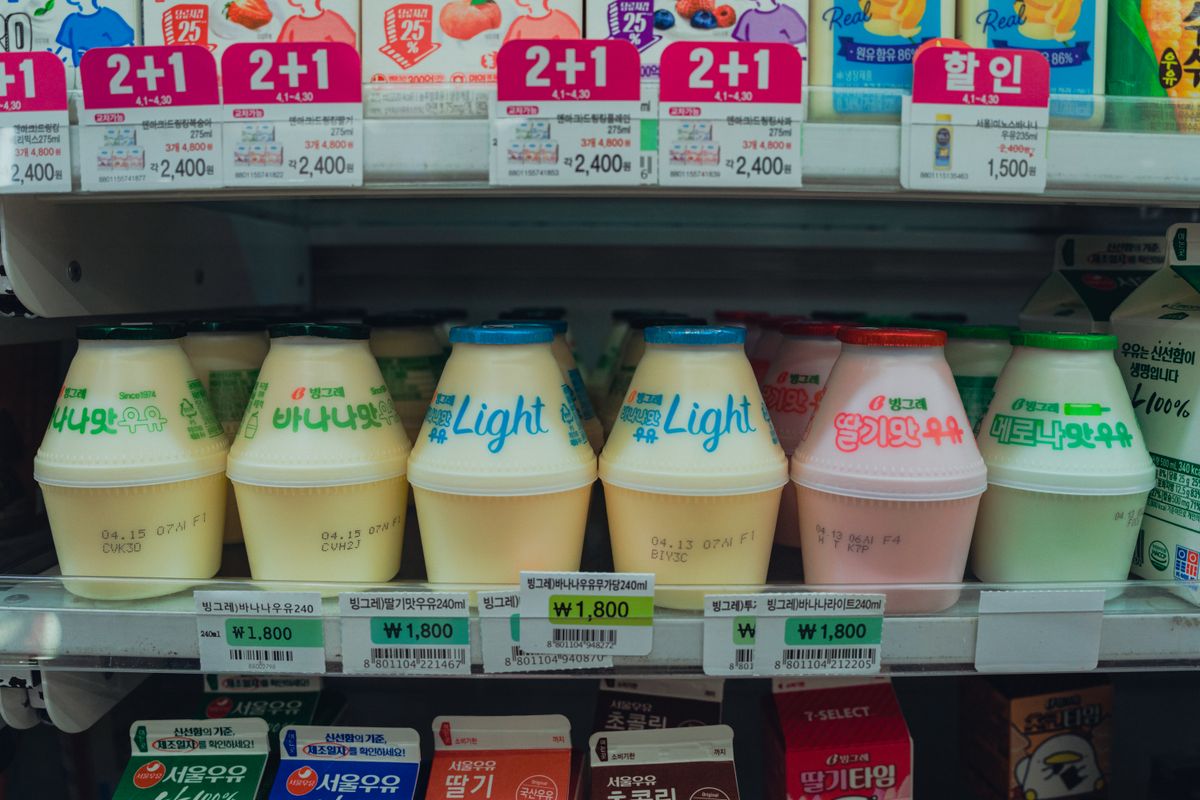 Vibrant assortment of Korean drinks in a convenience store fridge in Seoul, South Korea.