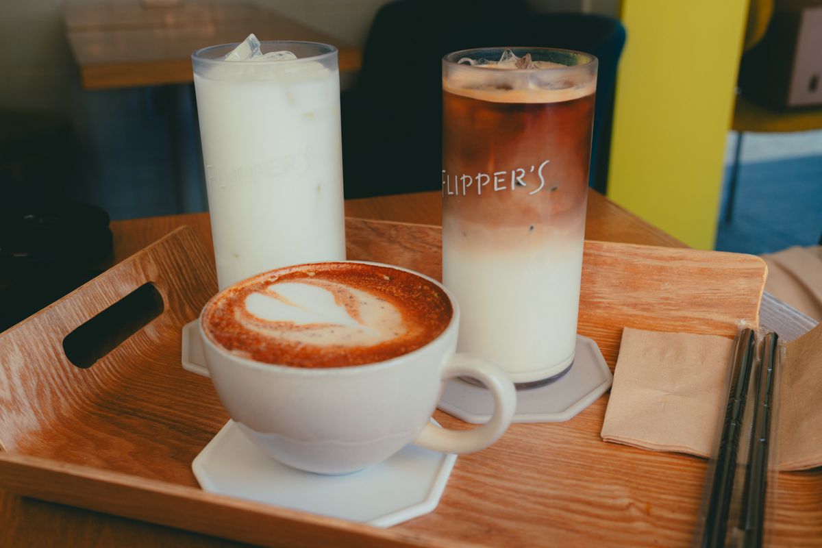A tray of coffee drinks and dessert-style cafe beverages in Seoul.