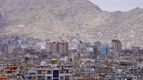 Free A panoramic view of Kabul city with high-rise buildings set against a mountainous backdrop. Stock Photo