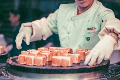 Free Chef prepares traditional sweets at a Beijing hutong street market. Stock Photo