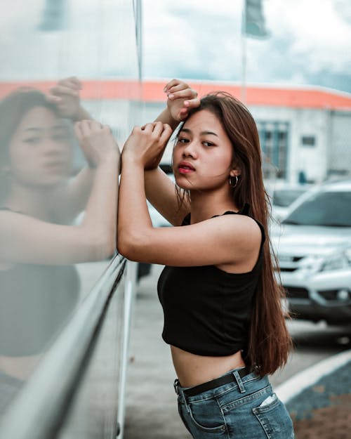 Woman in Black Crop-top Leaning on Wall