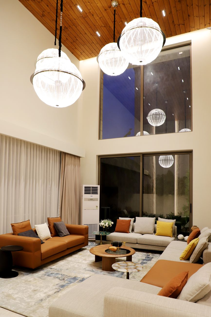 Spacious living room featuring modern decor, elegant lighting, and ceiling-to-floor windows.. pexels, spacious, living