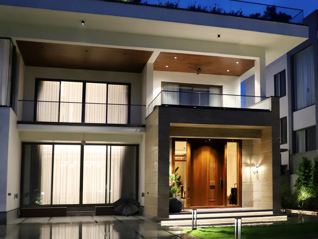 Modern home lit up at night Large modern house glowing with lights at night