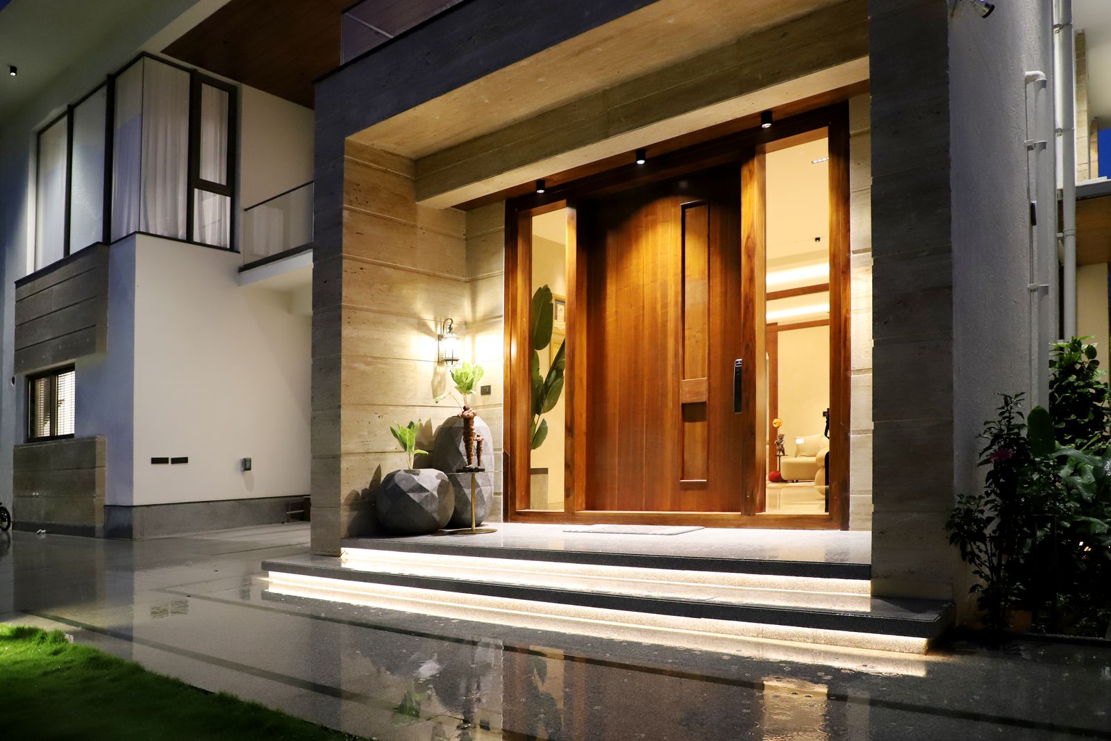 Illuminated modern home entrance at night