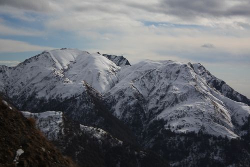 Free Scenic view of snow-covered mountain peaks under a cloudy sky. Stock Photo