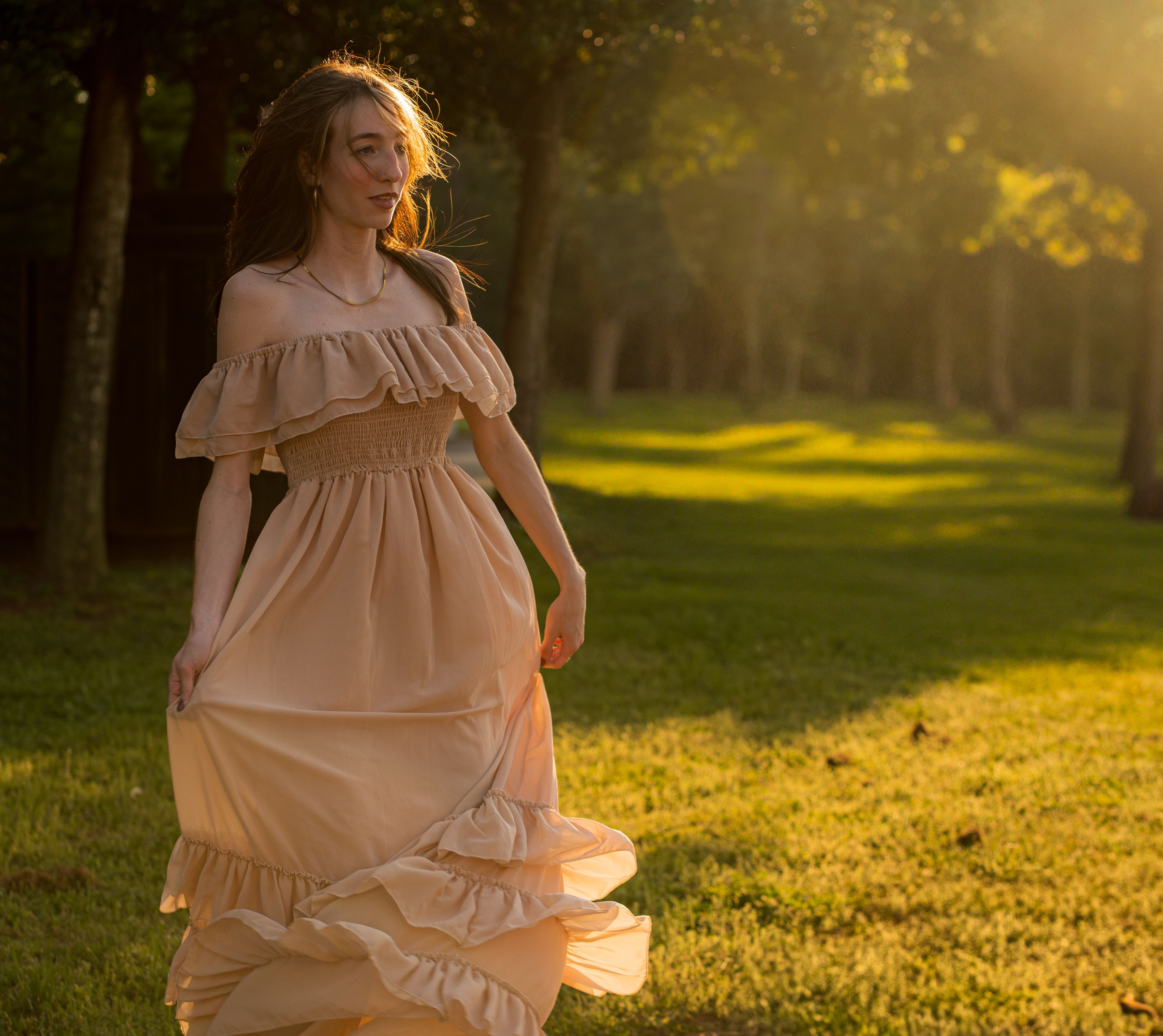 Elegant Woman in Flowing Dress at Sunset · Free Stock Photo