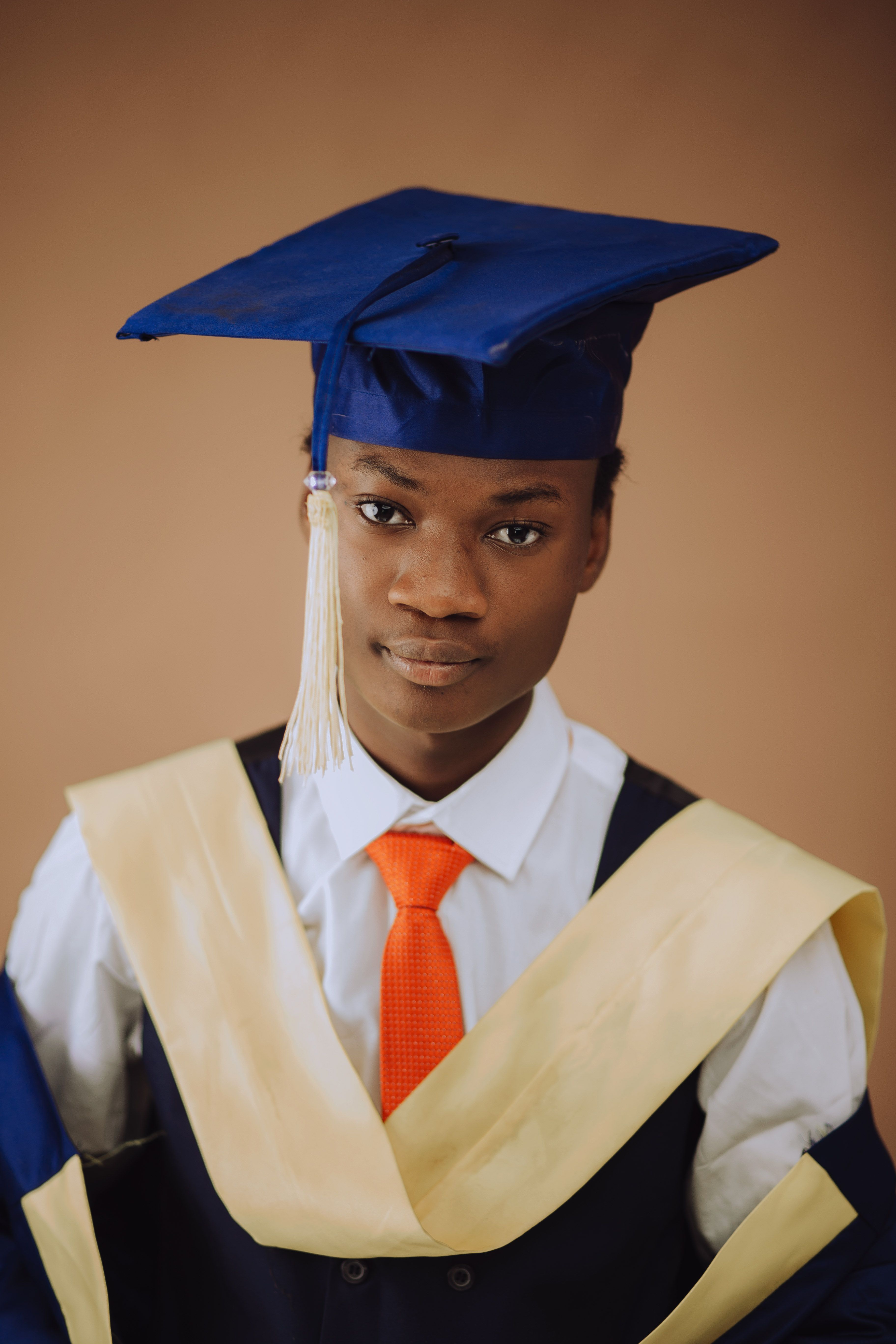 Young Graduate in Cap and Gown Portrait · Free Stock Photo