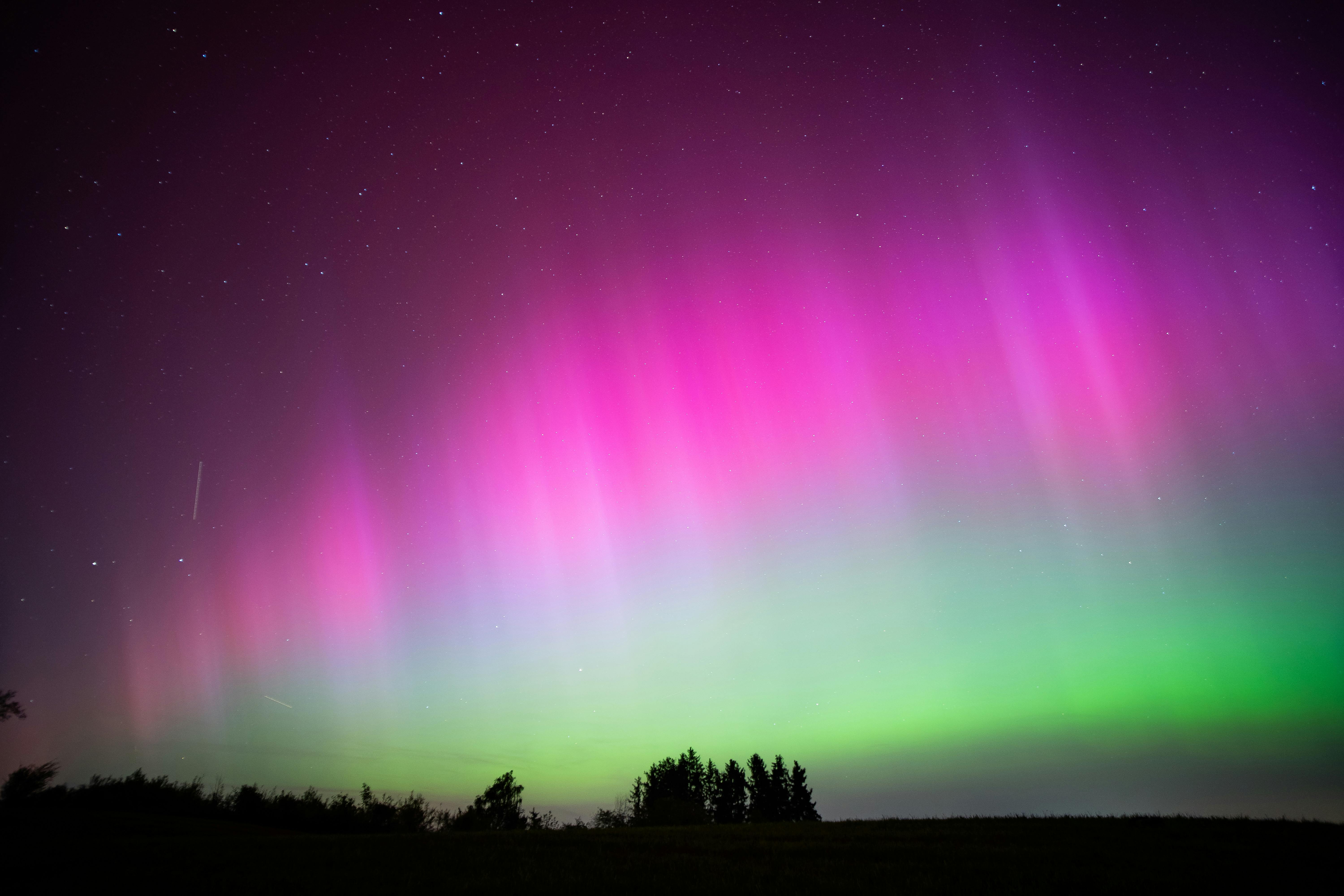 Capture the magical northern lights in vibrant pink and green hues over Stöttwang, Germany.