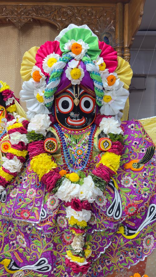 Free Hindu deity idol adorned with colorful floral garlands, showcasing Indian culture. Stock Photo