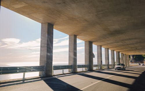Free Car driving through a concrete tunnel with ocean views in Shëngjin, Albania. Stock Photo