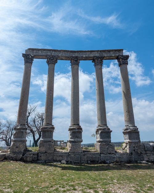 Free Explore the ancient Roman columns under a bright blue sky in Uzuncaburç, Mersin, Türkiye. Stock Photo