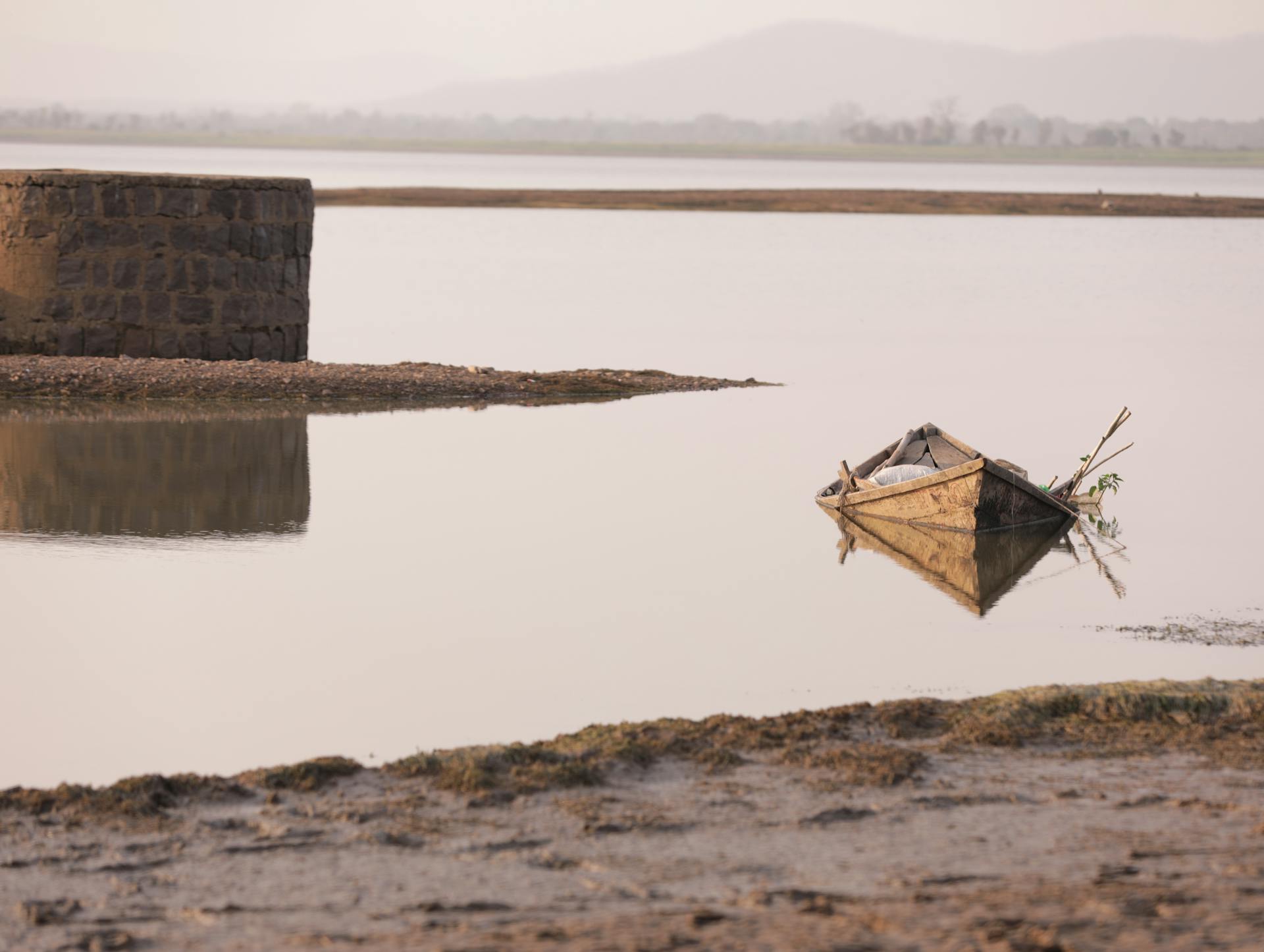 The boat is small and seems to be partially filled with water