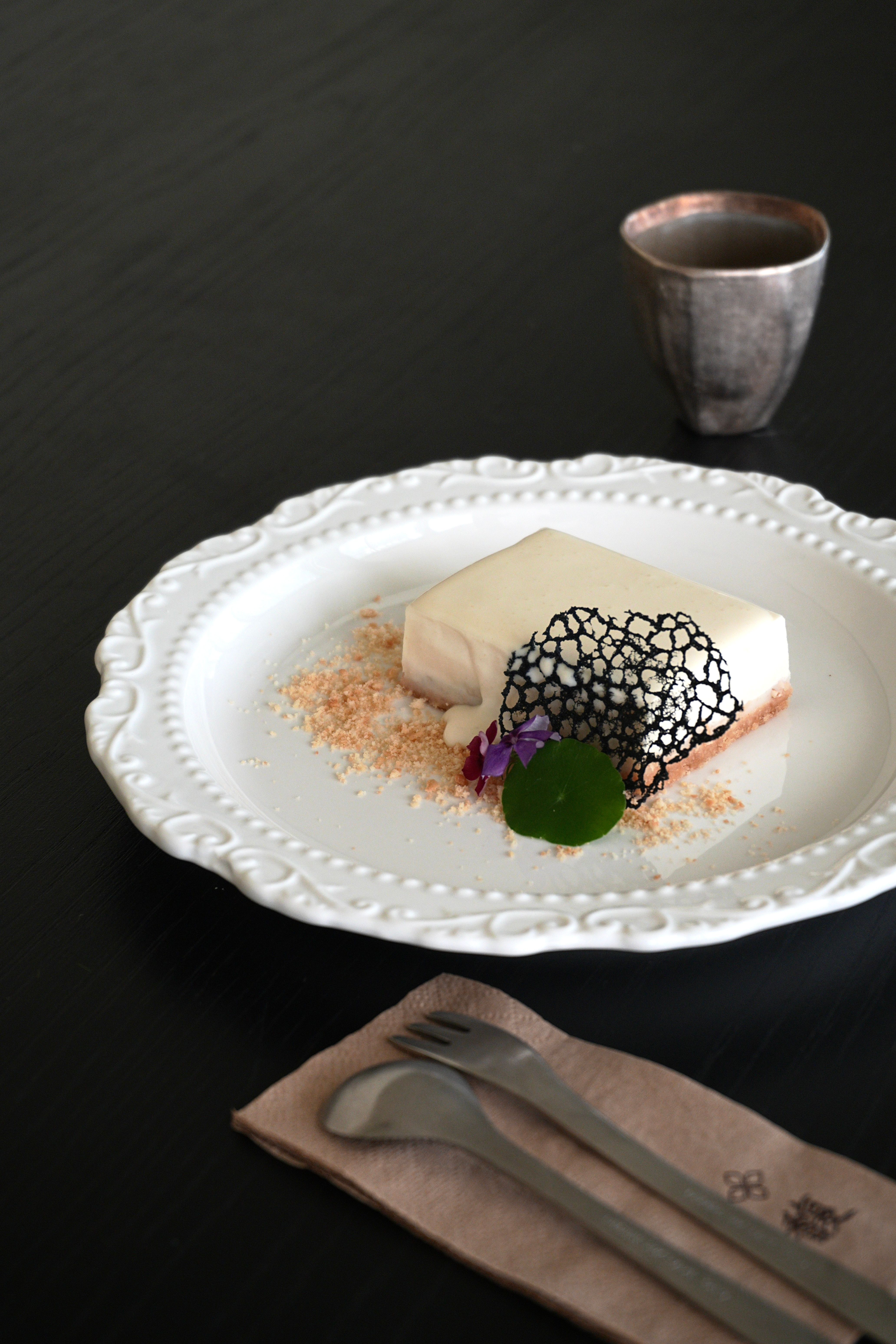 A sophisticated white chocolate dessert elegantly plated with artistic garnish.