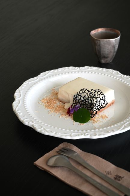 A sophisticated white chocolate dessert elegantly plated with artistic garnish.