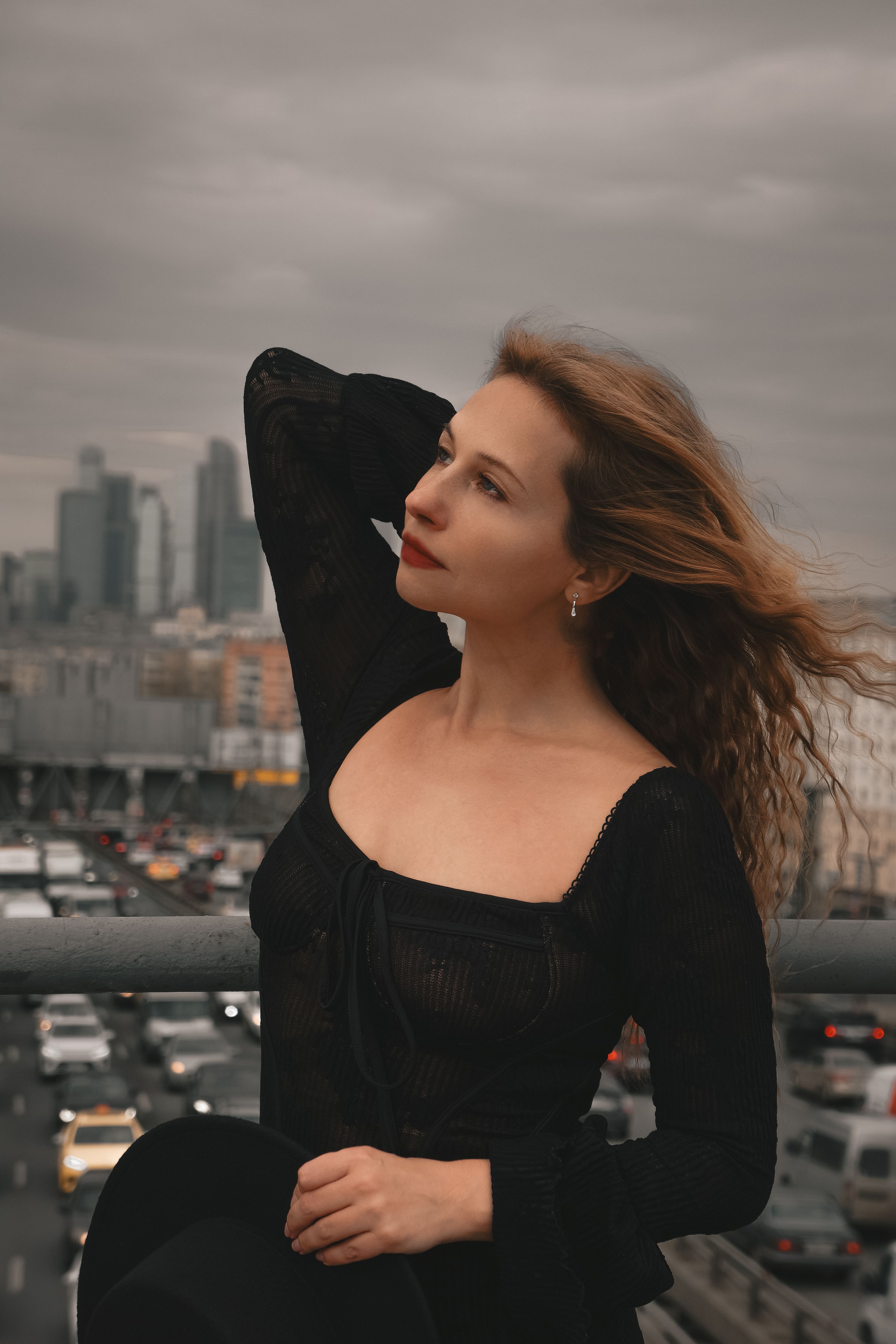 Contemplative Woman Posing on Urban Bridge · Free Stock Photo