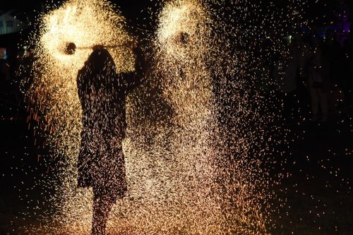 Free Silhouette of performer in fiery display during nighttime event. Stock Photo